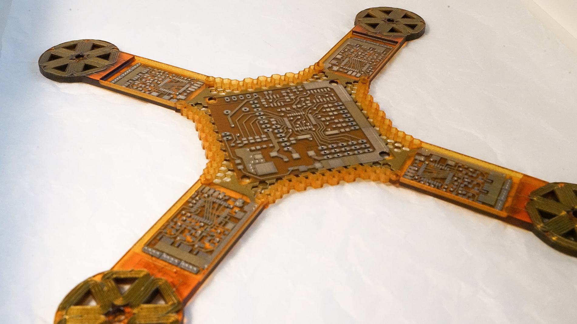 3D Printing of electronics is still a small field of Additive Manufacturing, but it promises enormous potential and a variety of new applications in the near future. The picture shows the basic electronic structure of a drone, including all the conductive tracks and the coils for the motors. Image: J.A.M.E.S.