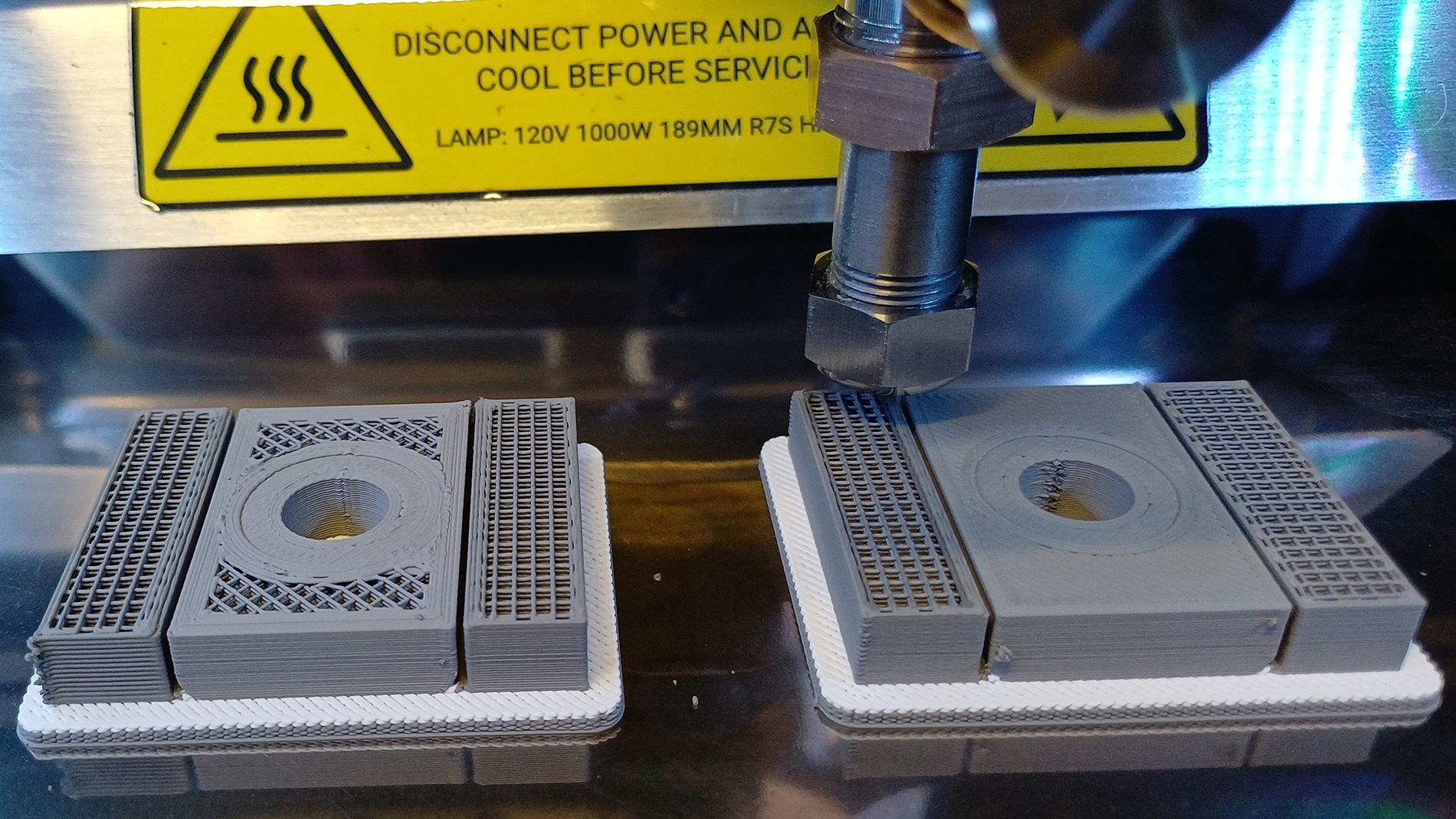 Challenger 3 prototype production part mid print – manufactured by Metal Paste Deposition using 17-4PH Stainless Steel and Ceramic Paste. Lightweighted on left and full infill on right. Image: RBSL