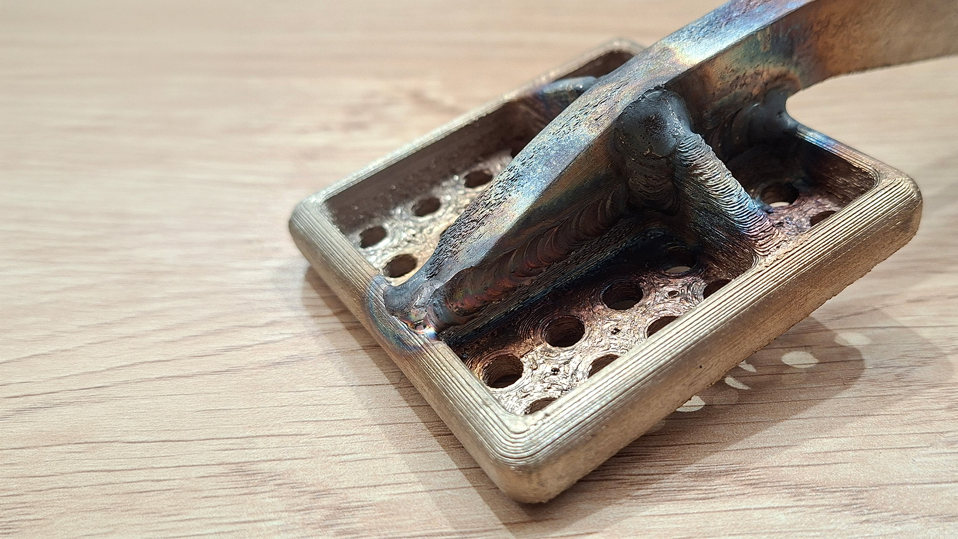 Prototype Land Rover brake peddle printed in 4 sections with Metal Paste Deposition in 17-4PH Stainless Steel and TIG welded together to optimized production cost and time. Image: RBSL